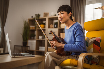 Mature japanese woman have online class learn how to play violin
