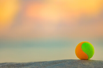 Beach tennis ball. Background with copy space. Sport court at the beach and ball.