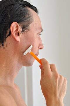 homem com gilete tirando a barba 