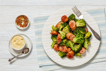 fried juicy sausage and crispy broccoli on plate