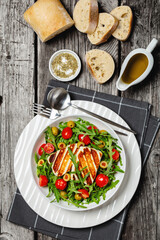 salad with grilled halloumi greek cheese in bowl