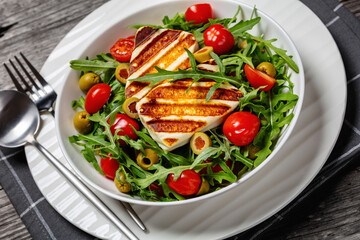 salad with grilled halloumi greek cheese in bowl