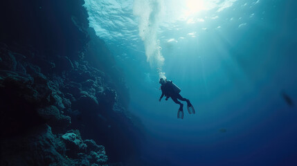 Fototapeta premium A person swimming in the water close to a cave entrance