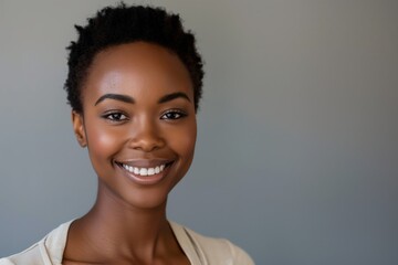 Smiling young attractive curly haired black woman looking at the camera