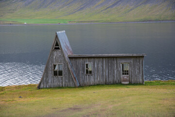 An abandoned cottage in Fossfjordur in the Icelandic westfjords - 795778879