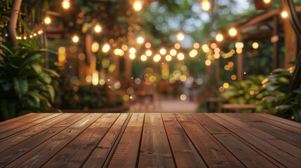 Empty wooden table with a dreamy bokeh of string lights in a lush garden setting