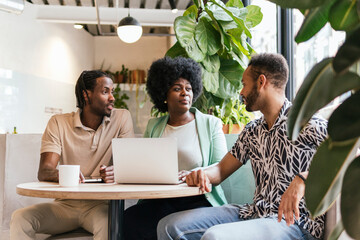 Diverse Team Engaged in a Discussion at a Co-working Space