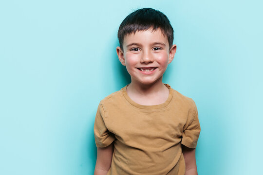 Cheerful boy smiling in a studio setting