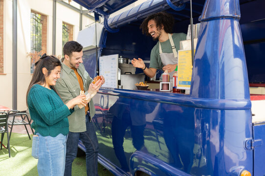 Enjoying Street Food at a Colorful Food Truck