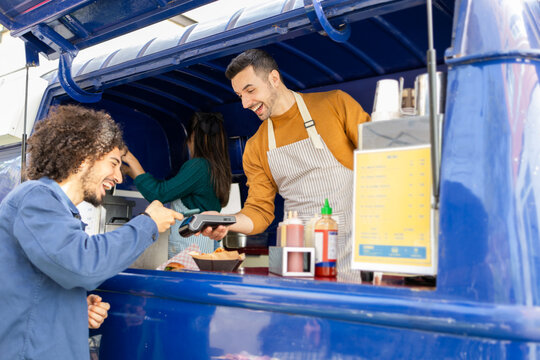 Smiling friends enjoying the food truck service