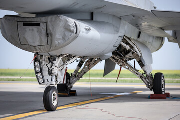 Fighter aircraft in parking position. Detail with landing gear.