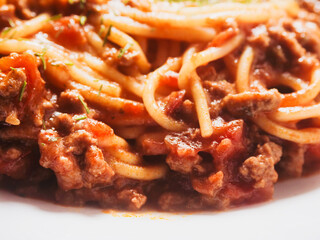 Spaghetti Bolognese serving on a white dish. Premium high quality meal with pasta, minced meat and...