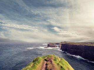 Kilkee cliff in county Clare, Ireland. Popular travel area with stunning nature scenery with green...