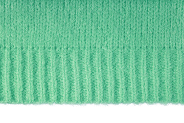 Green knitted woolen jersey fabric, sweater, pullover texture with edge isolated on white,...