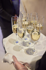 Table with champagne stemware and man in background at event