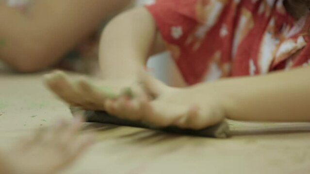 child playing with clay on the table