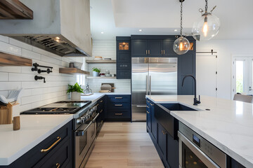 Contemporary modern kitchen interior in navy dark blue colors and concrete elements.