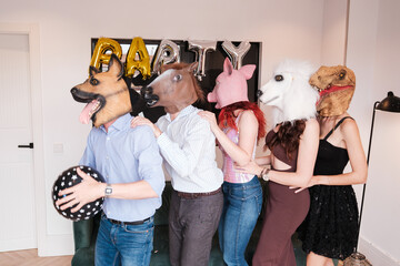 Group of friends celebrating together with animal masks at a very fun party. Concept: lifestyle
