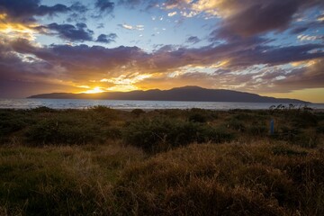 Naklejka na ściany i meble Sunset over Kapiti Island. Paraparaumu Beach, Paraparaumu, Wellington, New Zealand.