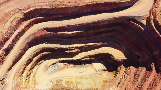 Around open pit copper ore mine in Cobar town of Australia -aerial top down view.
