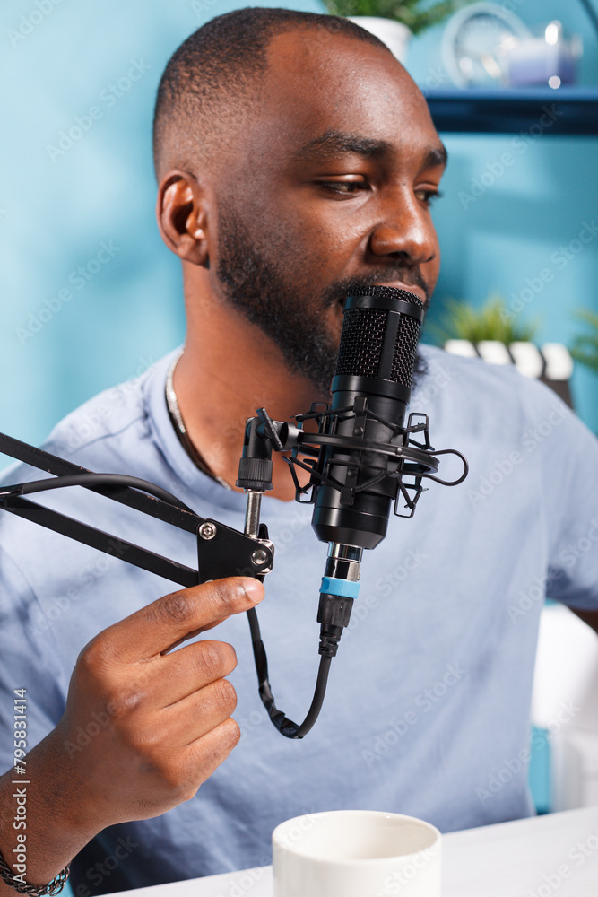 Poster african american vlogger speaking in microphone on internet podcast channel. young man blogger talki