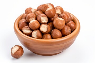 Obraz premium A bowl of nuts is on a white background. The bowl is filled with nuts, and there are many of them