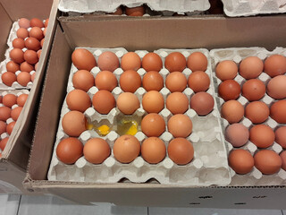 Fresh organic farm brown eggs in carton boxes at a supermarket