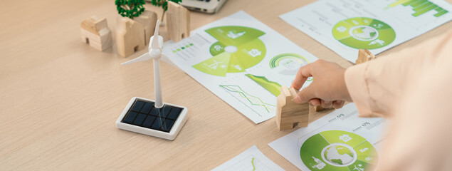 Environmental documents and a windmill model representing the use of clean energy are scattered on...