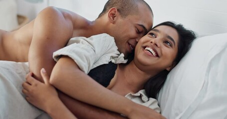 Happy couple, hug in bed and love with cuddle and romance at home for relationship, smile and bonding. Young people, woman and man relax in bedroom, intimacy and laughing with kiss and talk together
