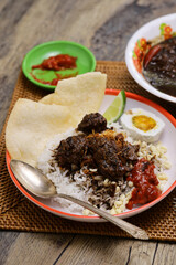 nasi rawon, black beef soup with rice.  Indonesian cuisine.