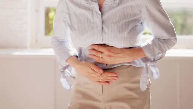 Woman Sitting On Sofa Suffering
