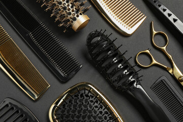 Hairdressing tools on dark background, flat lay