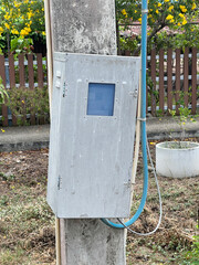 old rusty electric pole on a street background