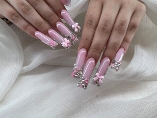 Pretty in Pink: Extra Long Acrylic Nails with Silver Rhinestones and Pink Bow Accents
