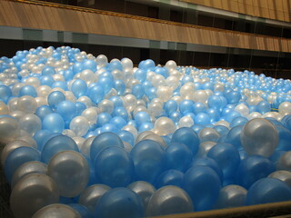 close up of a mound of blue and white balloons
