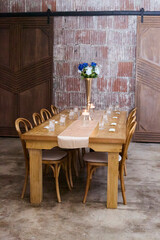 Decorated long event table. Table runner and flowers. 