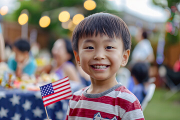 Cute portrait of little Asian American boy celebrating 4th of July with barbecue in the backyard
