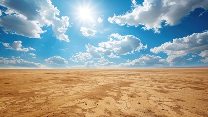 Fototapeta premium Arid desert landscape under bright sun with blue skies and clouds