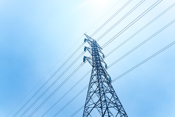 High voltage transmission towers on the background of the blue sky.