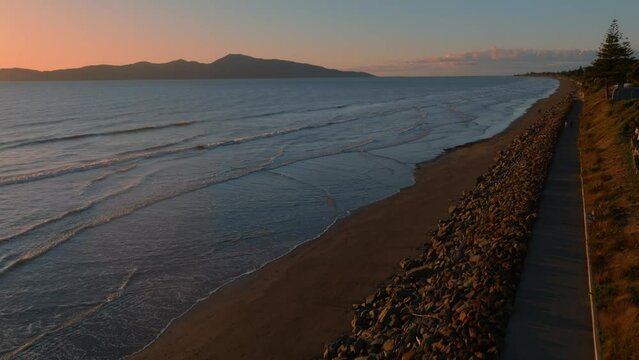 Aerial: Paraparaumu beach and Kapiti Island at sunset, wellington, New Zealand.