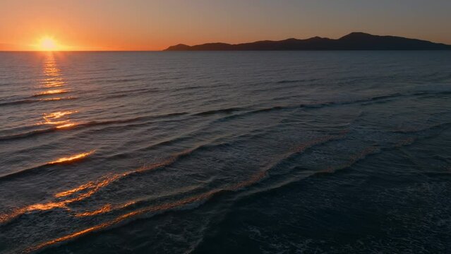 Aerial: Paraparaumu beach and Kapiti Island at sunset, wellington, New Zealand.