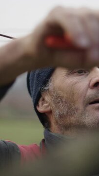 Closeup of a man pruning his vineyard
