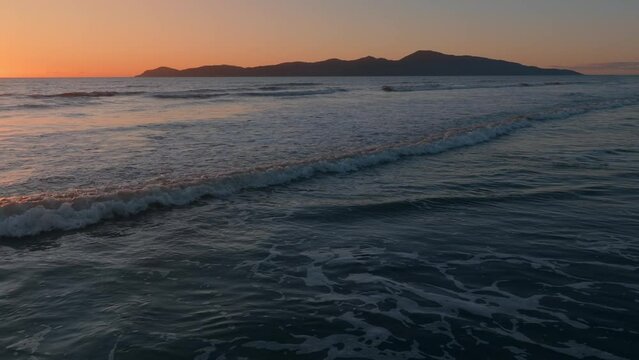 Aerial: Paraparaumu beach and Kapiti Island at sunset, wellington, New Zealand.