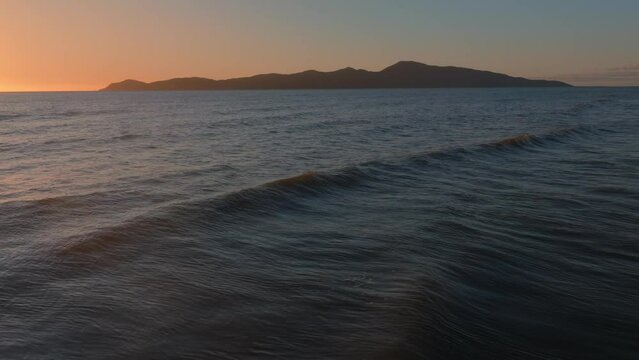Aerial: Paraparaumu beach and Kapiti Island at sunset, wellington, New Zealand.