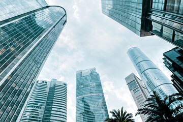 Blue glass skyscraper towers with angled geometric shapes, bottom view