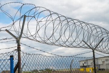Barbed wire fence. Razor wire. Restricted area. Airport protection.