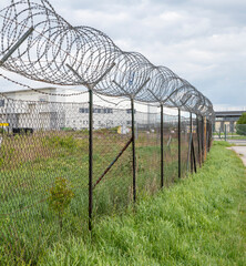Barbed wire fence. Razor wire. Restricted area. Airport protection.