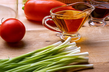 Olive oil in glass creamer. Ingredients for making vegetable salad