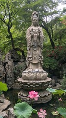 b'A stone statue of Guanyin surrounded by lotus flowers and trees'
