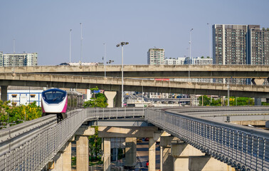 Urban view railway tracks suburban monorail electric trains rushing on bridge overpass supports...